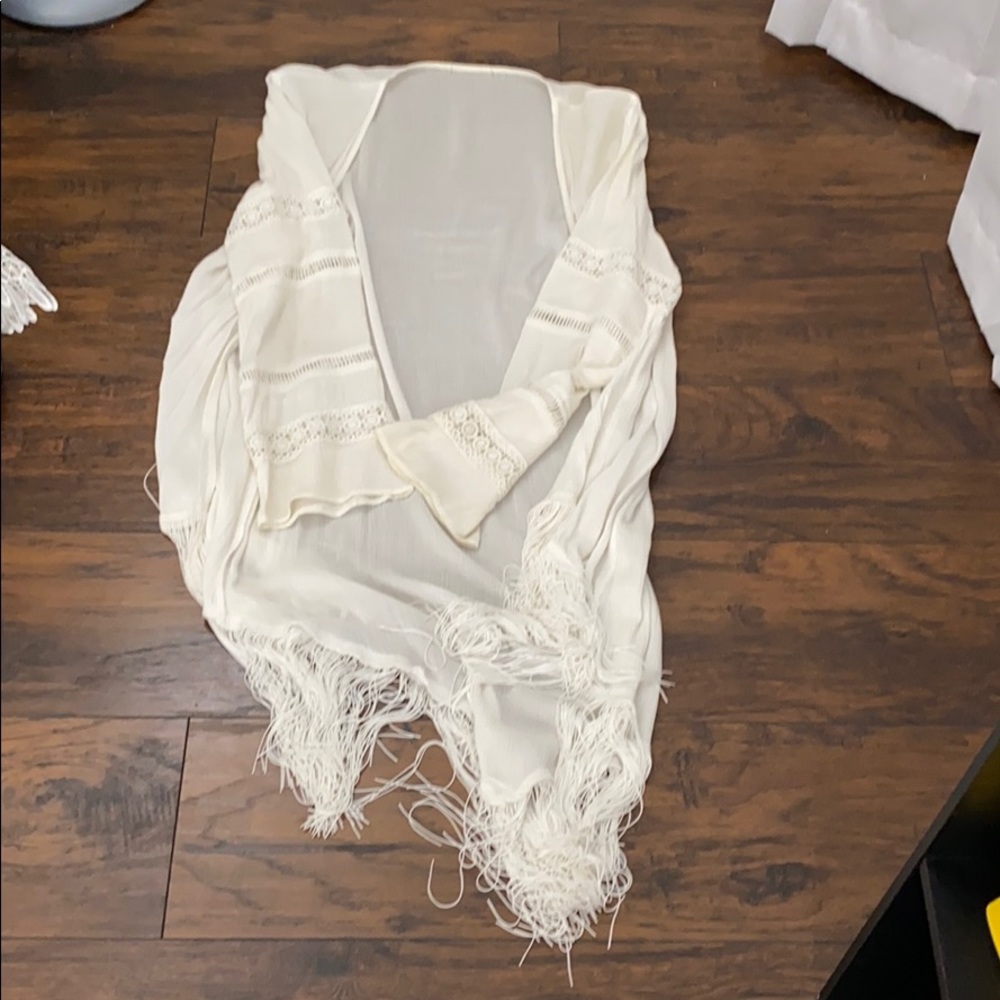 White fringed cardigan.